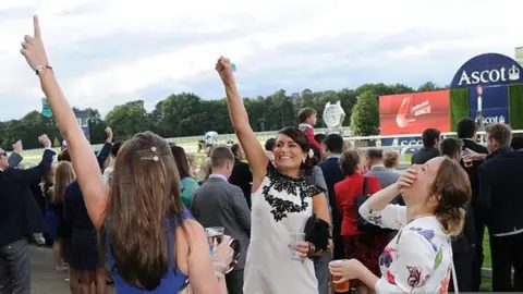 Getty Images Racegoers enjoying a drink