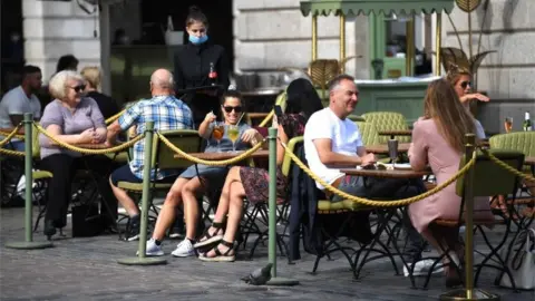 EPA People eat in a restaurant in Covent Garden, London