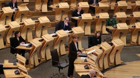 PA Media Nicola Sturgeon speaking in the Scottish Parliament