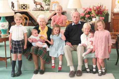 Duchess of Cambridge Pictured (left to right) Prince George, Prince Louis being held by Queen Elizabeth II, Savannah Phillips (standing at rear), Princess Charlotte, the Duke of Edinburgh, Isla Phillips holding Lena Tindall, and Mia Tindall. 14 April 2021