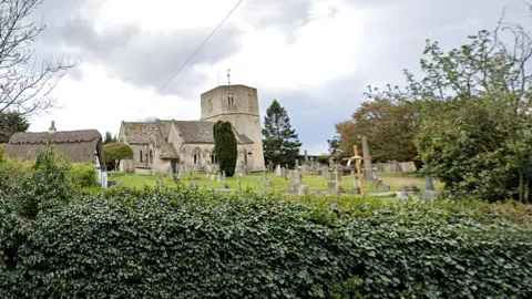 Google Church of St Lawrence viewed over a hedge