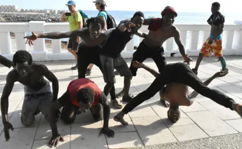 EPA African migrants celebrating on the seafront in Ceuta, Spain - Wednesday 22 August 2018