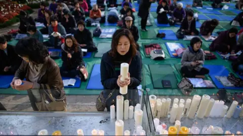 Getty Images Parents pray for their children's success at a temple in Seoul