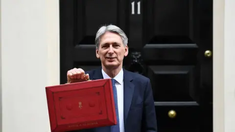 AFP Philip Hammond outside 11 Downing Street before March's Budget