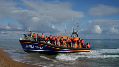 PA Media A group of people rescued by the RNLI arrive in Kent