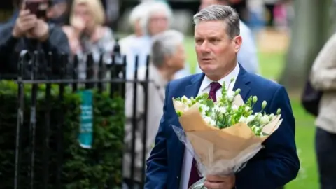 PA Media Sir Keir Starmer lays flowers in the September 11 Memorial Garden in Grosvenor Square, London