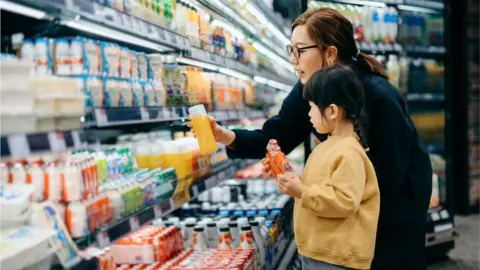 Getty Images Mother and daughter in a supermarket