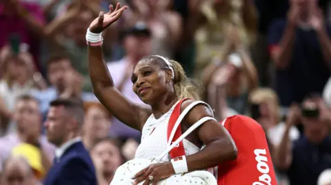 Serena Williams waves to the Wimbledon crowd