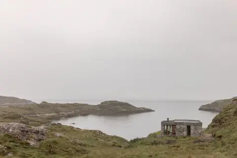 Richard Gaston Caoghan na Creige - The stone-clad building blends effortlessly into the rugged Hebridean landscape