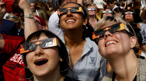 Reuters People enjoying the eclipse