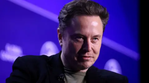 Reuters Elon Musk giving a speech with a a blue background