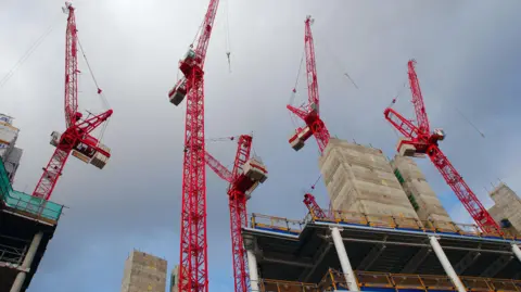 Getty Images Cranes above construction site