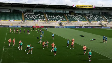 Getty Images England players warming up at Franklin's Gardens on Friday for training