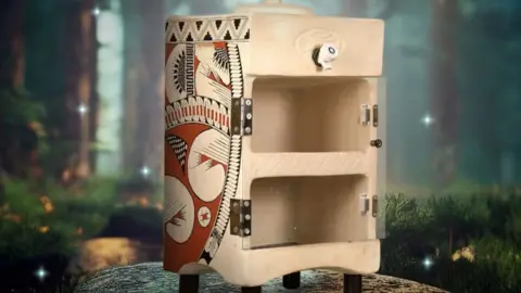 Mythicool a miticool clay refrigerator - not much larger than a microwave oven, with decorative models on the side.