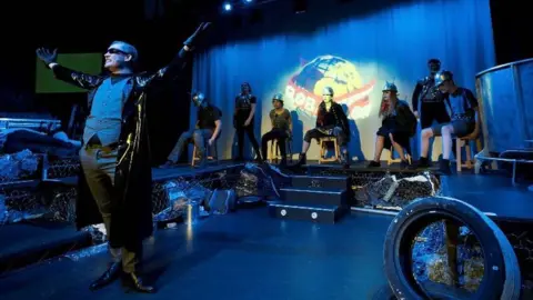 Tim Dickeson Adam Greenslade performing as Khashoggi in We Will Rock You