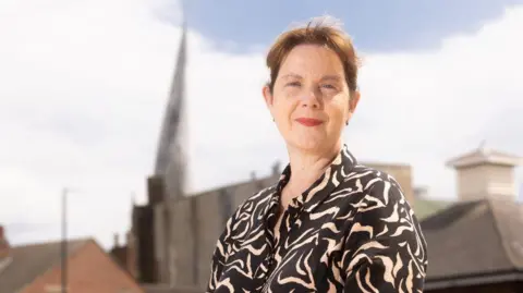 ACJ Media Claire Ward standing in front of the Crooked Spire in Chesterfield