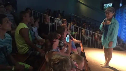 Janine Zeitlin Vicki talking to the crowd before the show