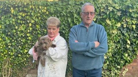 Lynn Holdom and her husband Alan Bamford with Ruby the dog