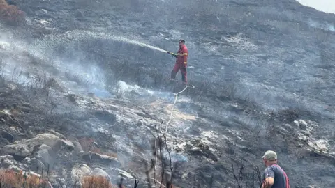 Derbyshire Fire and Rescue Service Firefighters tackling a fire on a moor