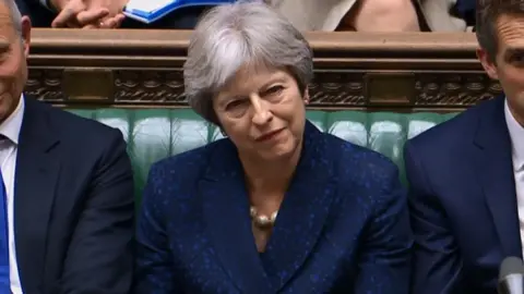 AFP Britain's Prime Minister Theresa May (C) listens in the Commons