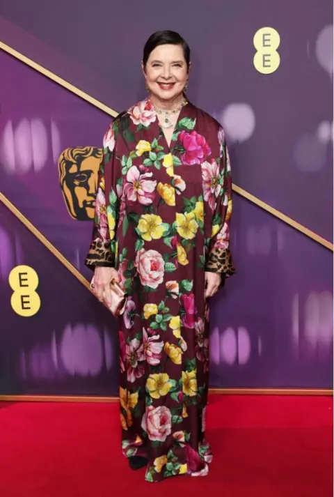 Getty Images Isabella Rossellini in a purple, pink and yellow floral long, floaty dress