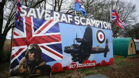 Reuters A banner at the gates of RAF Scampton