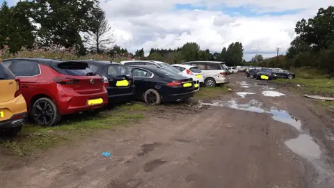 Cheshire Police Cars parked on muddy field