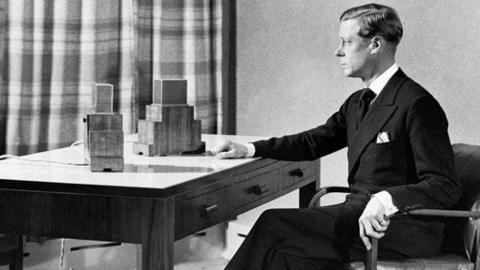 King Edward VIII sits at his desk with microphones