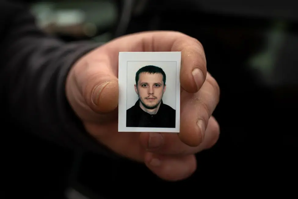 BBC The passport picture Serhiy carried while he searched for his brother