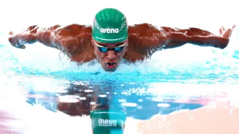 Matt McNulty/Getty Images Man swimming in pool, 9 August 2023