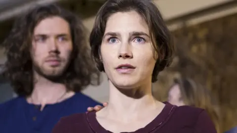 Getty Images Amanda Knox speaks to the media, with fiance Colin Sutherland, in front of her parents' home in Seattle, Washington (March 27, 2015)
