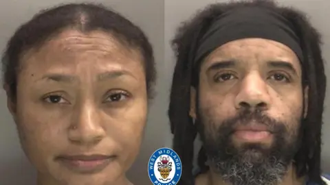 Tamara and Damion Thomas pictured in a mugshot with no expression on their faces. Tamara has he hair slicked back behind her while Damion has thick shoulder length dreadlocks and wears a thick black headband across his forehead. 