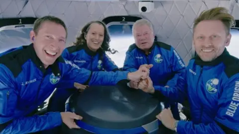 Reuters Glen de Vries, left, with other passengers, including William Shatner, centre right, on Blue Origin’s New Shepard last month