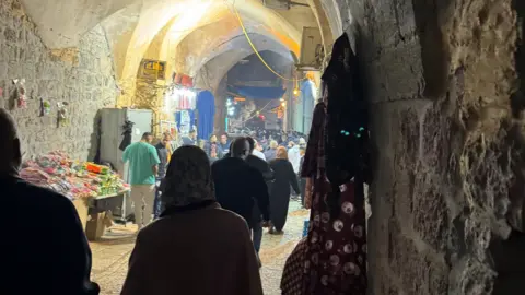 Sebastian Usher People walking inside a souk in the Old City of Jerusalem