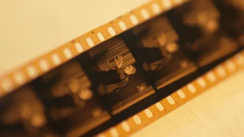 Film reel with image of man holding out his hand in a 'stop' gesture 