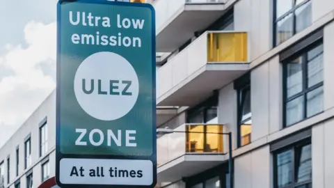 Getty Images Green ULEZ sign in front of flats