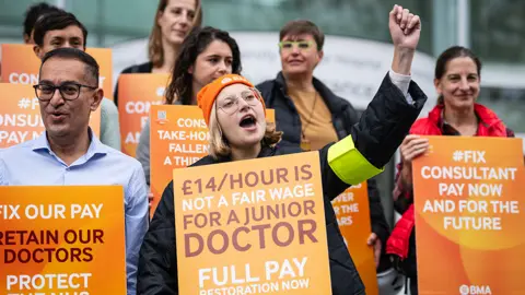 Getty Images Junior doctors and consultants at University College Hospital London with placards