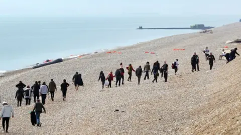 PA Media Migrants on the beach