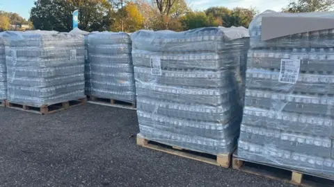 Pallets of water waiting for collection