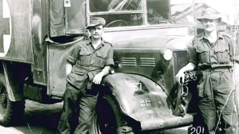 Albert Morrow Two men standing beside ambulance vehicle, wearing military uniforms