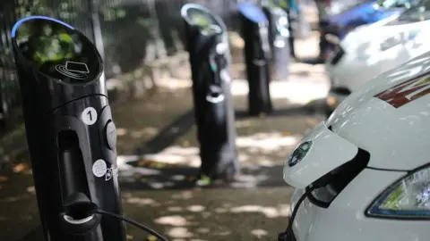 Getty Images A charging plug connects an electric vehicle (EV) to a charging station on August 17, 2017 in London