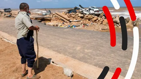 A man looks at flood damage in Derna