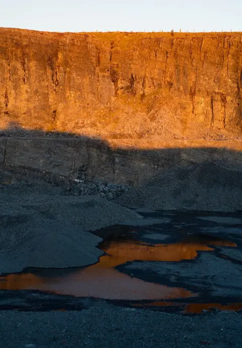 Jon Pountney Adisused quarry half in shadow, half in sunlight