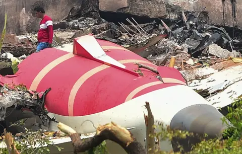 AHMEDABAD, INDIA - JUNE 13: Investigative officials stand at the site of Air India Boeing 787 which crashed yesterday, on June 13, 2025 in Ahmedabad, India. An Air India Boeing 787 Dreamliner, flight AI-171, carrying 242 passengers and crew members en route from Ahmedabad to London Gatwick, crashed shortly after takeoff on June 12, 2025, after the pilot issued a mayday call to air traffic control. The aircraft crashed into the densely populated Meghani Nagar area near Sardar Vallabhbhai Patel International Airport, resulting in a massive explosion and fire due to the heavy fuel load for the international journey, with rescue operations ongoing. (Photo by Ritesh Shukla/Getty Images)