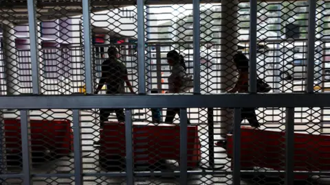 Getty Images Mexican nationals walk with their luggage through the U.S-Mexico border on July 7, 2012 in Nogales