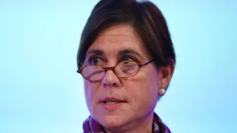 Getty Images Baroness Lampard wearing glasses and with her hair in a bun