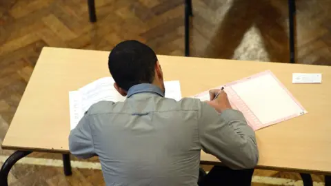 General view of anonymous (anon) school pupil taking examination.