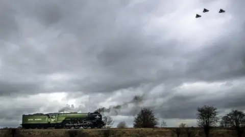 PA Three RAF Tornados fly past the Tornado train near Leeming Bar in Yorkshire during their farewell tour.