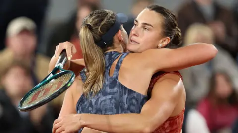 Aryna Sabalenka hugs Paula Badosa after their French Open match