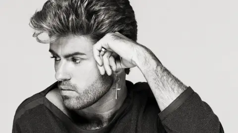 Brian Aris A black and white image of a young George Michael.